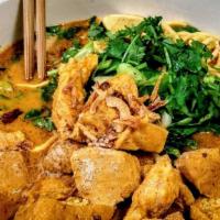 Curry Mee With Young Tau Foo · Egg noodle in spicy & sour lemon grass broth served w. fried tofu & vegetable stuffed fish p...