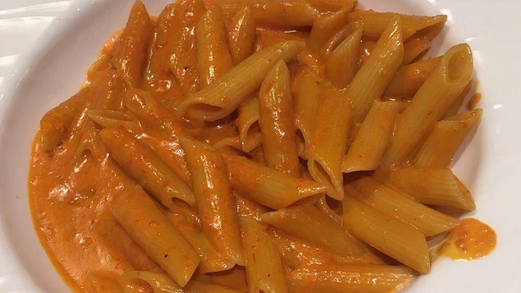 Penne Alla Vodka · Our homemade creamy pink vodka sauce served over penne pasta and sprinkled with grated parmesan cheese.