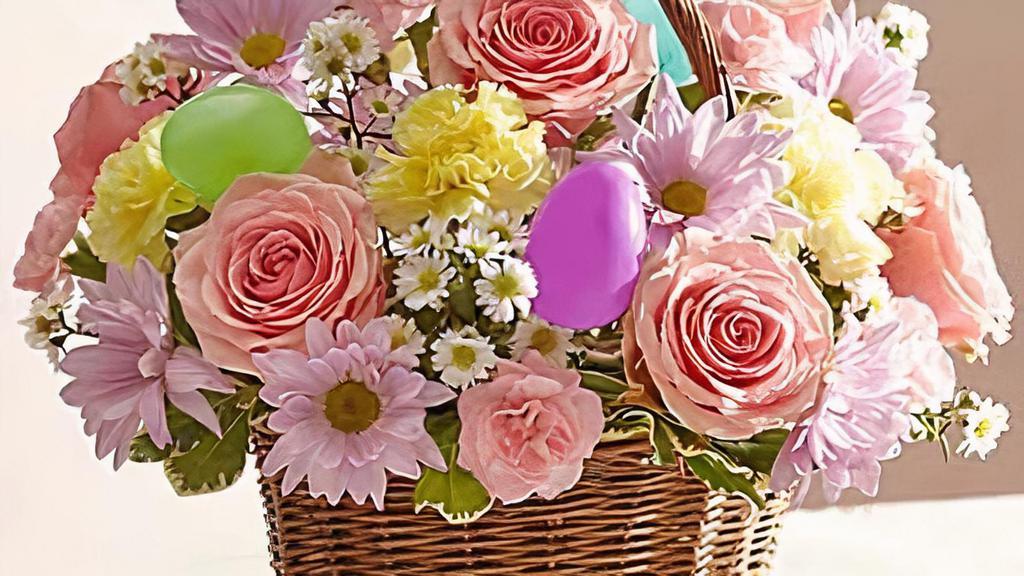 Easter Basket Arrangement  · Our beautiful wicker basket is filled with the colors of Spring, including roses, daisy poms, carnations and more.  A great way to say Happy Easter!
As Shown