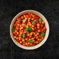 Chickpea Masala (Vegan) · Whole chickpeas, slow cooked till soft in an onion and tomato curry with Indian whole spices...