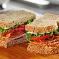 Tavern Club Sandwich · Ham, smoked turkey breast, bacon, cheddar cheese, lettuce, tomato,  mayo and honey mustard o...