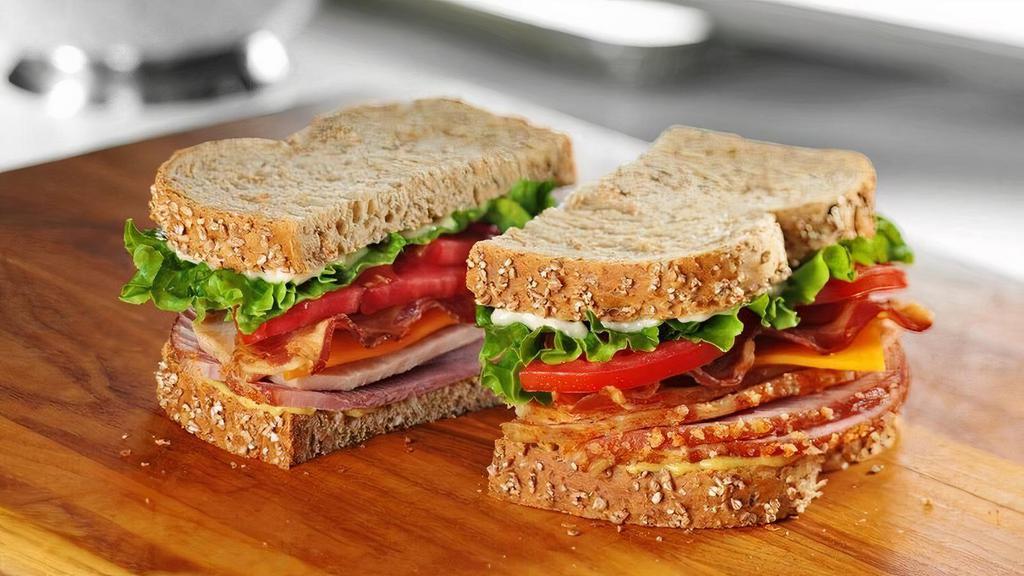 Tavern Club · Honey Baked Ham and smoked Turkey Breast piled high with bacon, cheddar cheese, lettuce, tomato, Duke’s® Mayonnaise and Dijon Honey Mustard on multigrain bread. 1010 cal.