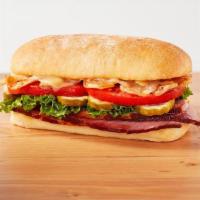 The Honeybaked · New! Honey Baked Ham topped with Swiss cheese, lettuce, tomato, pickles, crispy onions, Duke...