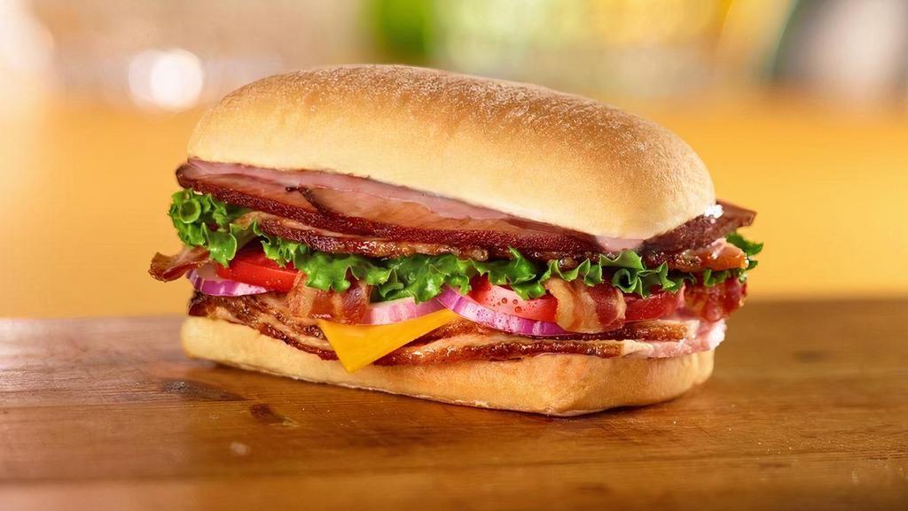 Bbq Smoked Stacker Sandwich · Honey Baked Ham, bacon, cheddar cheese, lettuce, tomato, red onion and smoky BBQ sauce on ciabatta.
