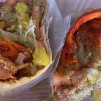 The G.E. Shredder Wrap · Spicy red chicken and turkey, sauteed onions, melted Jack cheese, and onion rings, dressed w...