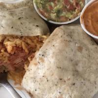 Spicy Red Chicken Burrito · Includes rice with peas, guacamole, sour cream, and melted mozzarella cheese. Served with to...