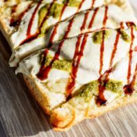 Pesto Margherita Flatbread · four cheese blend, sliced tomato, fresh mozzarella, balsamic glaze