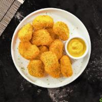 Chicken Nuggets · Bite sized nuggets of chicken breaded and fried until golden brown. (8 pieces)