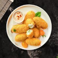 Jalapeno Poppers · (Vegetarian) Fresh jalapenos coated in cream cheese and fried until golden brown. (10 pieces).