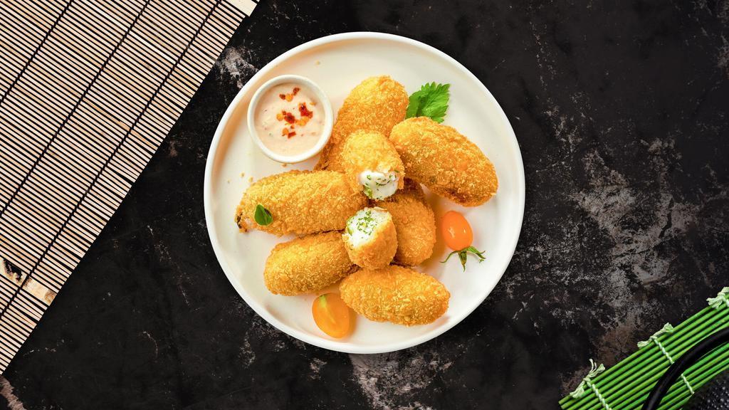 Jalapeno Poppers · (Vegetarian) Fresh jalapenos coated in cream cheese and fried until golden brown. (10 pieces).