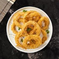 Onion Rings · (Vegetarian) Sliced onions dipped in a light batter and fried until crispy and golden brown.