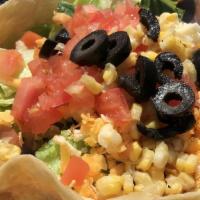 Fiesta Taco Salad · Large crispy flour tortilla topped with seasoned ground beef, romaine lettuce, corn, tomatoe...