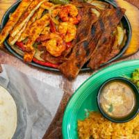 Fajitas Texanas Dinner · Chicken, steak and shrimp. Fajitas are served with onions, green peppers, charro beans, lett...