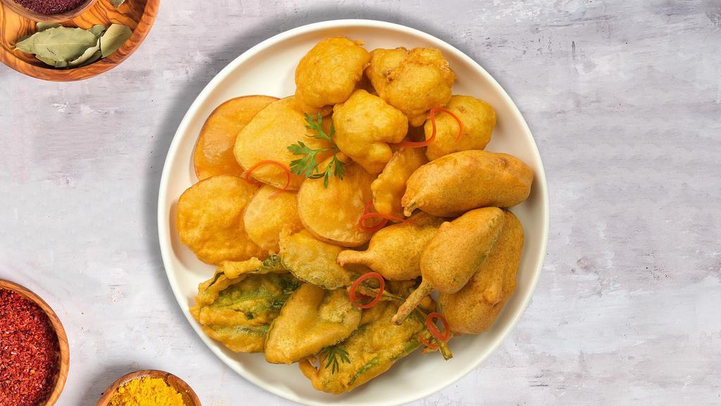 Pakora Darling · Assorted vegetables dipped in a light batter and fried until golden brown.