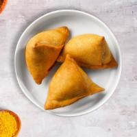 Classic Samosa · (Two pieces) Spicy seasoned potatoes and peas mixed in a curry marinate & fried in a crispy ...
