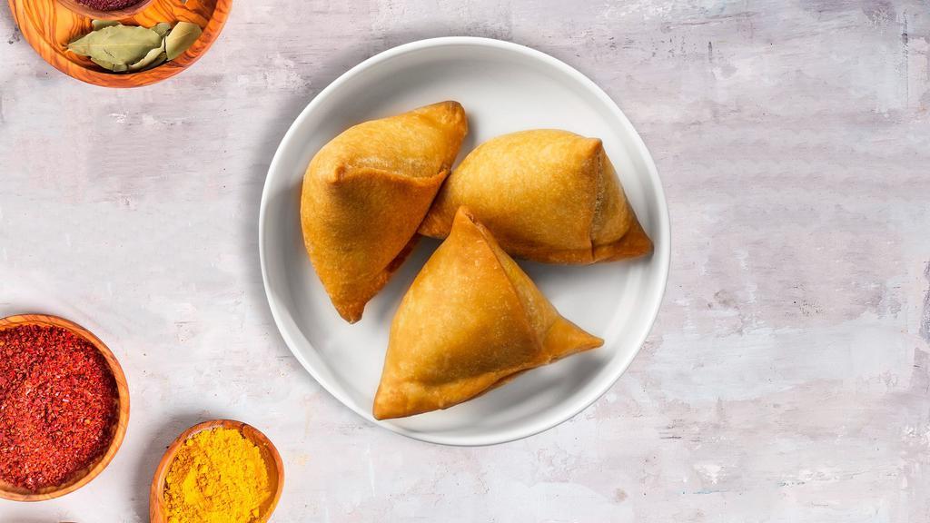 Classic Samosa · (Two pieces) Spicy seasoned potatoes and peas mixed in a curry marinate & fried in a crispy wheat layer.