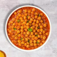 Burst Of Chana Masala · Chickpeas cooked in a ginger, garlic, tomato and onion gravy with Indian spices.