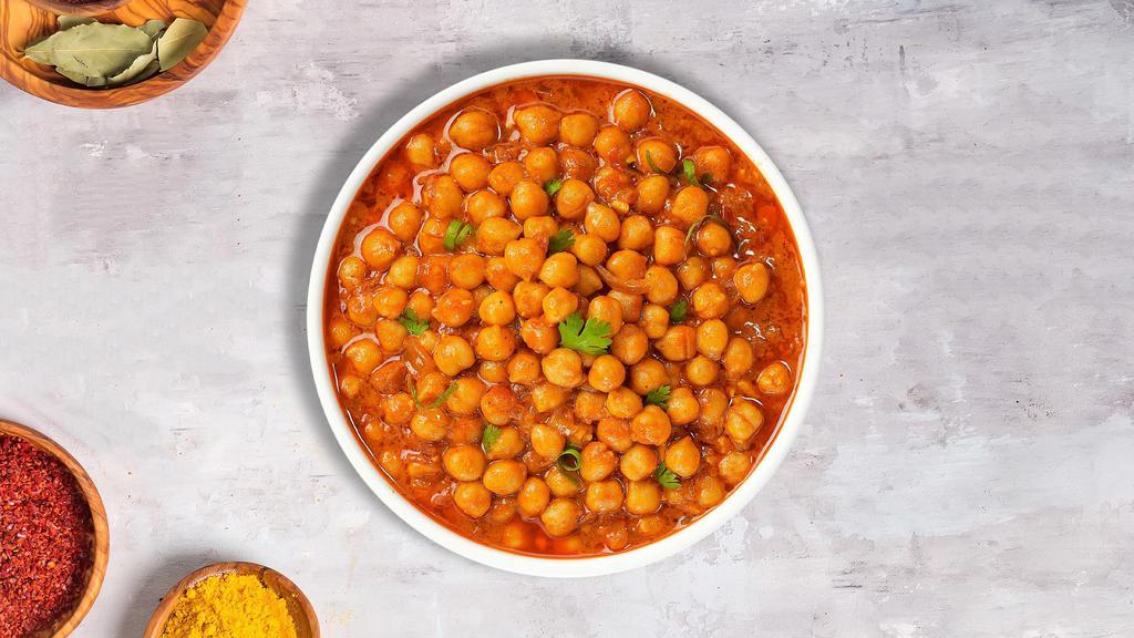 Burst Of Chana Masala · Chickpeas cooked in a ginger, garlic, tomato and onion gravy with Indian spices.