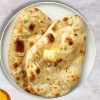 Garlic Naan Nights · Freshly baked bread in a clay oven garnished with garlic and butter.