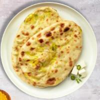Paneer Naan Pitcher · Freshly baked bread stuffed with cottage cheese cooked in a clay oven.