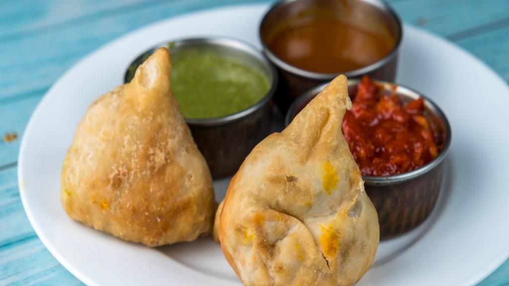 Vegetable Or Meat Samosa · Mildly spiced triangle vegetable or meat patties (2)