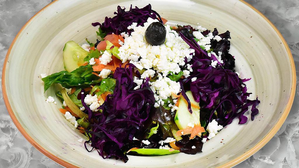 Kestane Salad · Sliced tomatoes, lettuce, red cabbage, carrots and cucumbers topped with shredded Feta cheese and dressing.