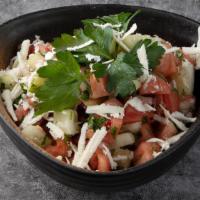Shepherd Salad · Fresh tomatoes, cucumbers, onions, parsley, and dressing.