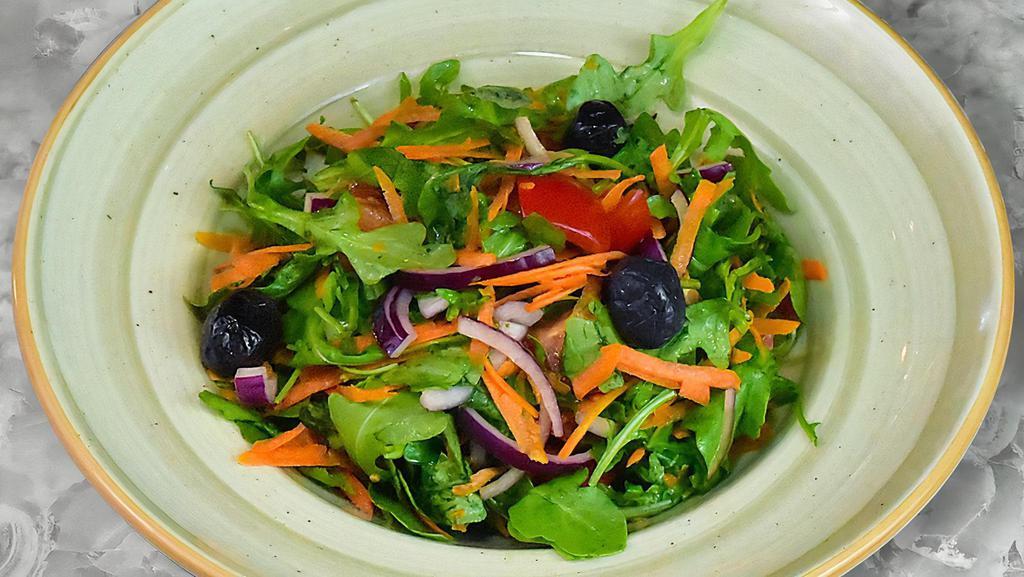 Arugula Salad · Fresh arugula, ripe tomato, red onion, and shredded carrots topped with olive oil, lemon juice, and vinegar.