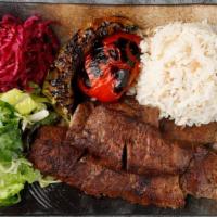Lamb Gyro · Doner. Vertically grilled lamb cut into very thin slices. Served with rice and greens.