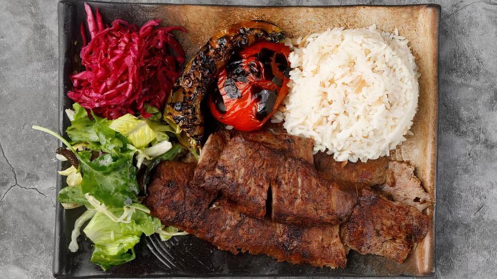Lamb Gyro · Doner. Vertically grilled lamb cut into very thin slices. Served with rice and greens.