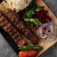 Lamb Adana Kebab · Hand chopped lamb seasoned with spicy red bell peppers, then char-grilled. Served with rice,...
