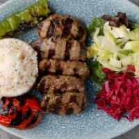 Kofte Kebab · Char-grilled Turkish meatballs. Served with rice, grilled tomatoes, peppers and onions, lett...