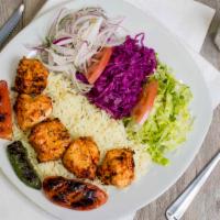 Chicken Shish Kebab · Marinated chunks of chicken char-grilled to perfection. Served with rice mixed salad, marina...