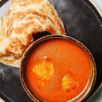 Crispy Indian Pancake · Crispy fluffy indian bread served with a curry dipping sauce.