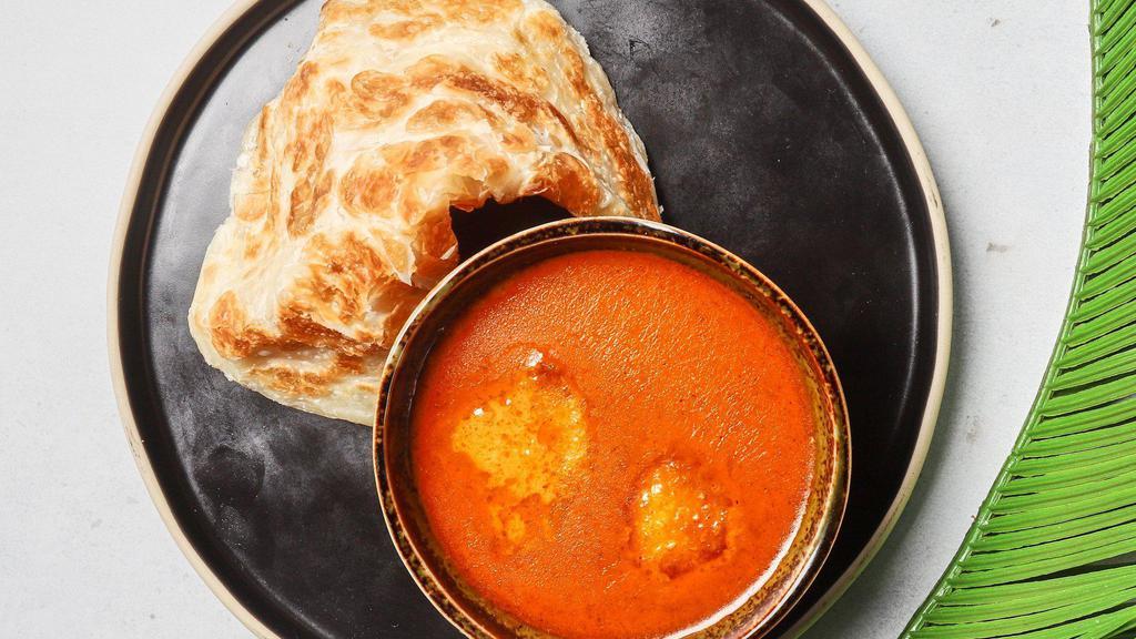 Crispy Indian Pancake · Crispy fluffy indian bread served with a curry dipping sauce.