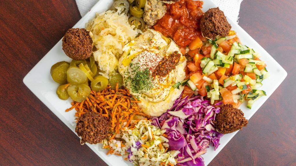 Small Falafel Plate
 · Assorted salads, hummus, and six falafel balls with a side of pita bread.