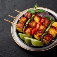 Paneer Tikka · Gluten-free. Cottage cheese, bell pepper, marinated in yogurt, and spices.