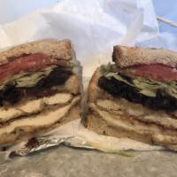 Chicken Club · Grilled chicken, smoked bacon, Brie cheese, plum tomatoes, and house dressing.