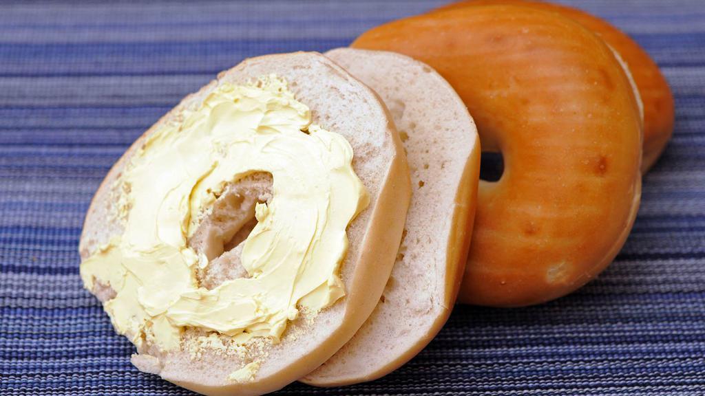 Butter On Bagel · Delicious warm bagel with butter spread.