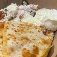 Carne Asada Quesadilla · Served in flour tortilla with Mexican cheese, sour cream, pico de gallo and cotija cheese.