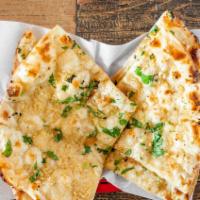 Garlic Naan · Naan Covered With Minced Garlic And Cilantro. Baked In The Tandoori Oven.