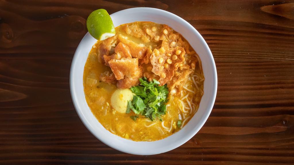 Mohinga Soup · Spicy. Burmese fish noodle soup. Thin rice noodles with Burmese fish noodles soup, ginger, lemongrass, onion, garlic, and fried rice powder, served with hard-boiled egg, crispy split chickpeas, cilantro, lemon, and crushed red chili.