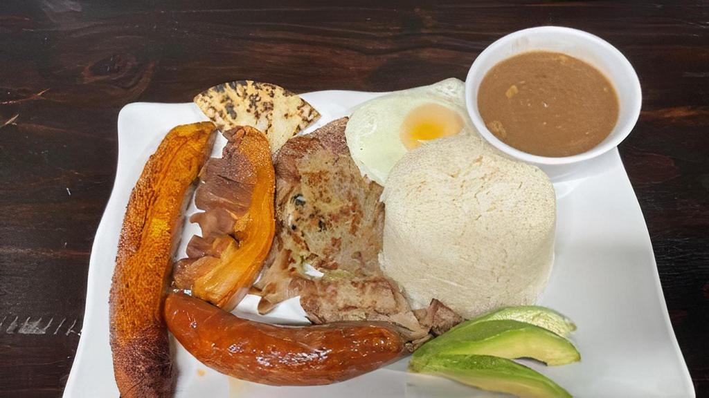 Bandeja Paisa · Rice and beans, steak, pork skin, arepa, sweet plantain, sunny side egg, and avocado.