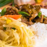 Curry Goat · Served with rice and peas or white rice and steamed vegetable or collard greens.