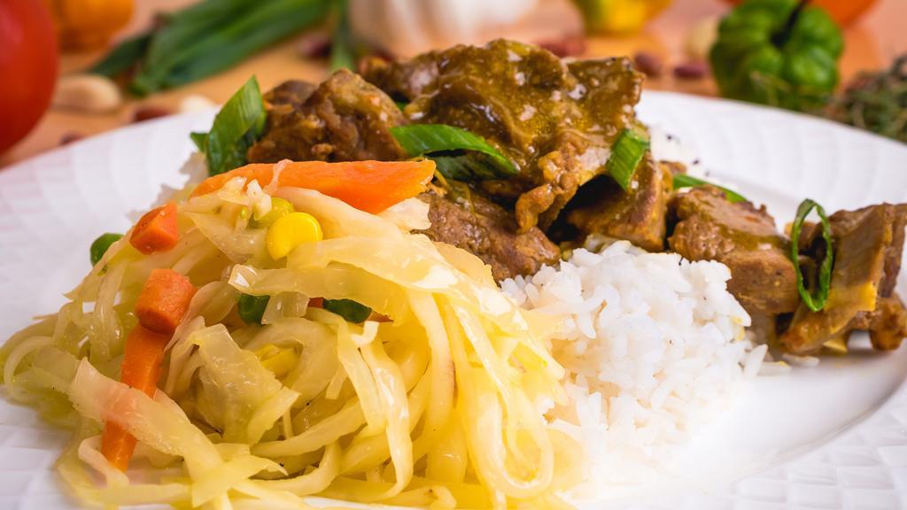 Curried & Goat Combo · Goat meat marinated in curry and other Caribbean spices. Served with rice and peas or white rice and steamed vegetables and plantains.
