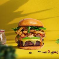 Fried Fries Feast Vegan Burger · Seasoned plant-based burger patty topped with fries, avocado, melted vegan cheese, carameliz...