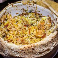 Hyderabadi Chicken Dum Biryani · Slow cooked chicken with yogurt and spices, saffron, basmati rice.