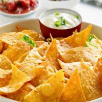 Nachos · A protein of your choice chips cheese beans, sour cream and cotija cheese