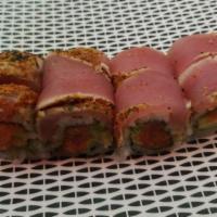 Crazy Tuna Roll · Spicy tuna, crunch and avocado wrap topped with pepper tuna and scallion.