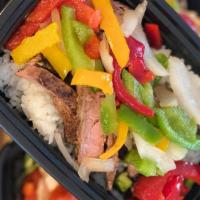 Steak Fajita · Flame grilled flank steak seasoned to perfection smothered with peppers and onions, served o...